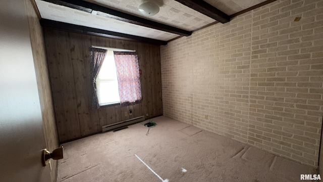 empty room featuring beamed ceiling, light colored carpet, baseboard heating, and brick wall