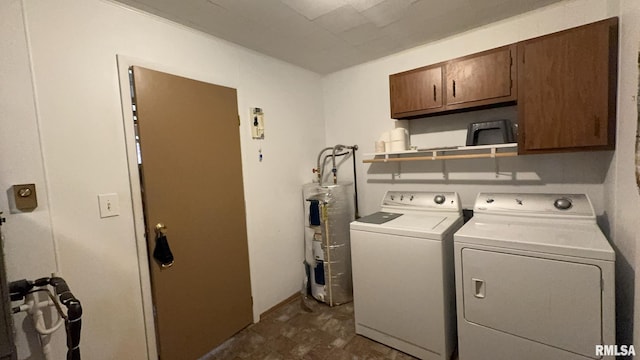 washroom with washer and dryer, cabinets, and water heater