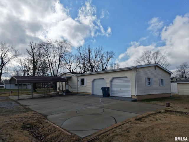 back of property with a carport and a garage