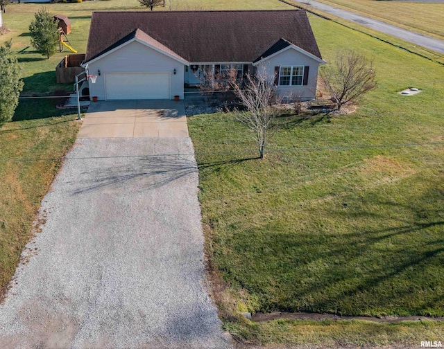 ranch-style house featuring a garage and a front lawn