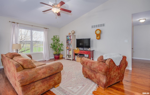 living room featuring ceiling fan, high vaulted ceiling, and light wood-type flooring