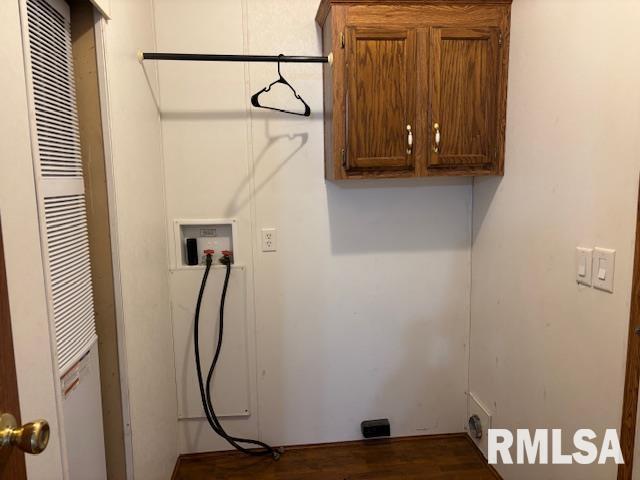 laundry room with cabinets, hookup for a washing machine, and dark hardwood / wood-style flooring