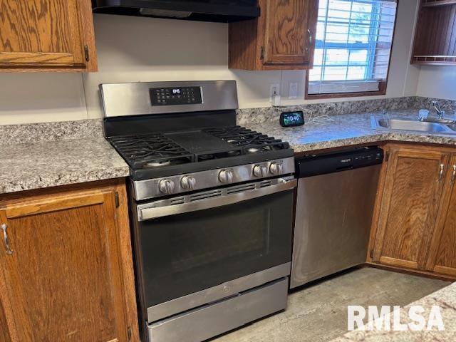 kitchen with extractor fan, sink, and appliances with stainless steel finishes