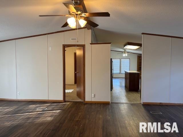 unfurnished room with a textured ceiling, ceiling fan, dark hardwood / wood-style flooring, and vaulted ceiling