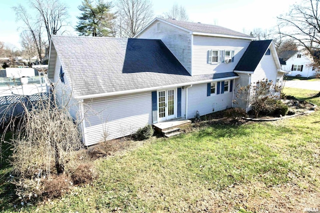 back of house featuring a lawn