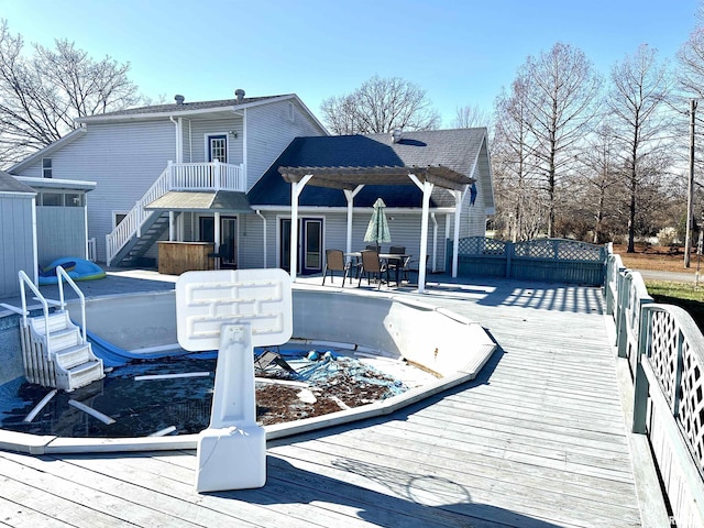 back of house with a pergola and a deck