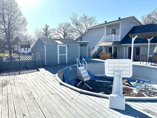 deck with a pergola and a storage shed