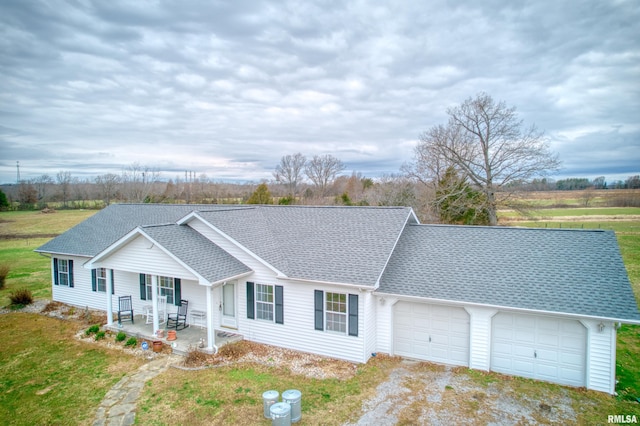 single story home featuring covered porch and a garage