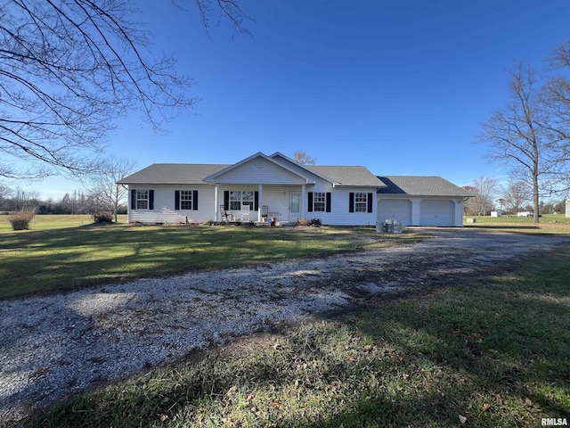 ranch-style home with covered porch, a front yard, and a garage