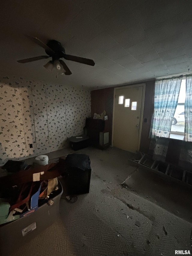 interior space with carpet flooring, plenty of natural light, and ceiling fan