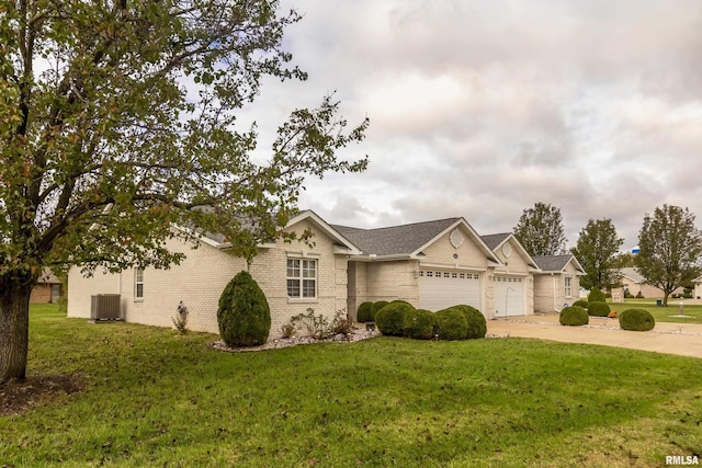 ranch-style house featuring central AC, a front yard, and a garage