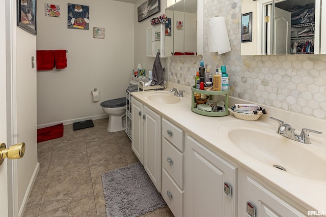 bathroom with decorative backsplash, vanity, and toilet