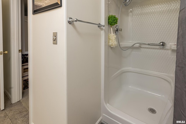 bathroom with tile patterned flooring and walk in shower