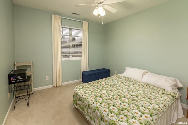 bedroom featuring light carpet and ceiling fan