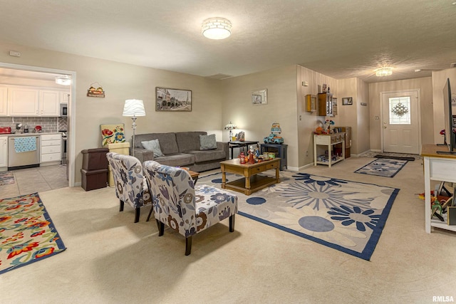 living room with a textured ceiling and light carpet