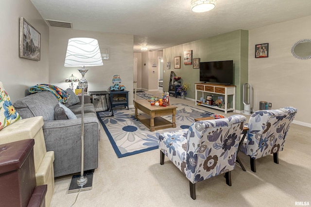 carpeted living room featuring a textured ceiling