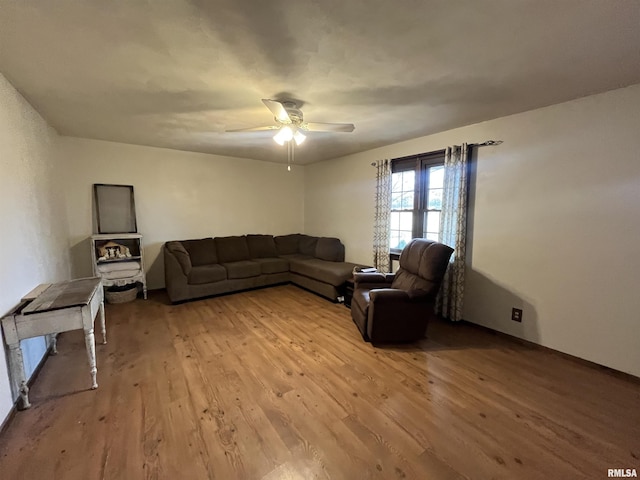 living room featuring light hardwood / wood-style flooring and ceiling fan