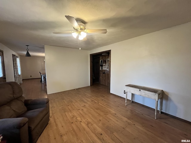 living room featuring hardwood / wood-style flooring and ceiling fan