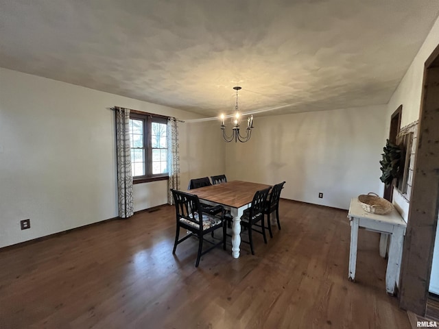 dining room with a notable chandelier and dark hardwood / wood-style flooring