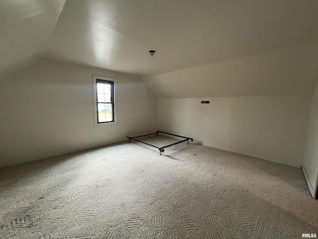 bonus room featuring carpet and vaulted ceiling