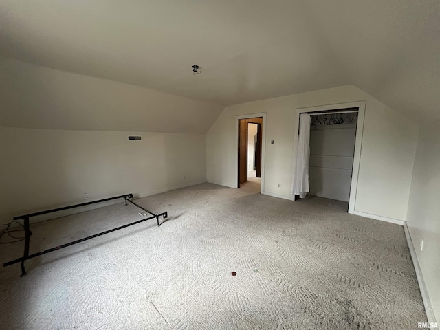 additional living space featuring vaulted ceiling