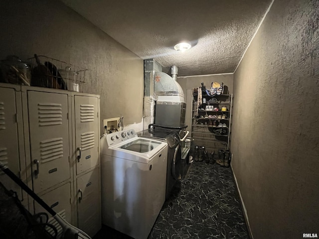 washroom featuring washer and dryer and a textured ceiling