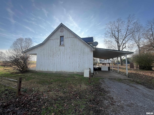 view of property exterior with a carport