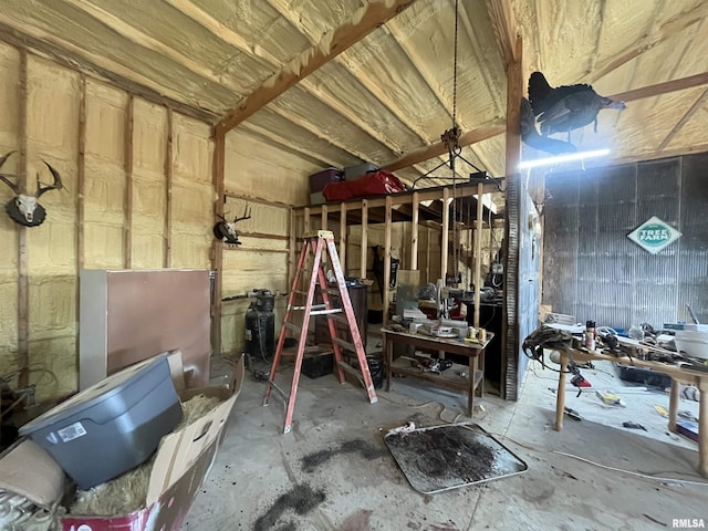 misc room with a workshop area and concrete flooring