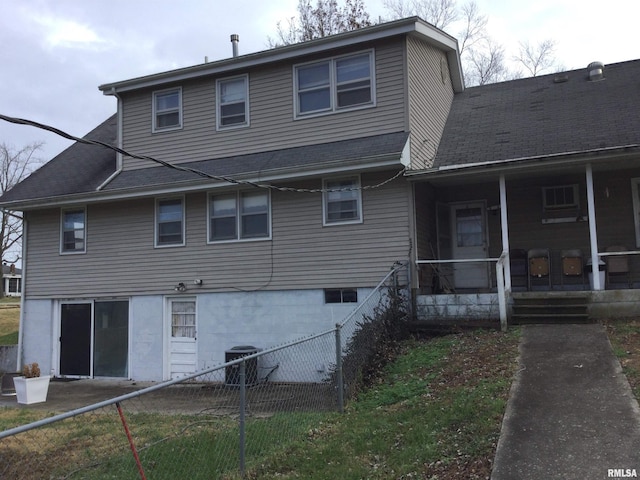 rear view of house featuring central AC