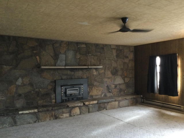 unfurnished living room with baseboard heating and ceiling fan