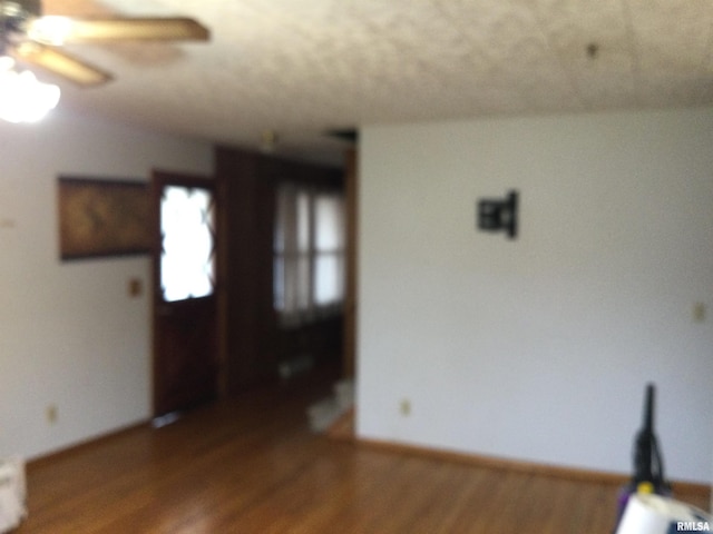 unfurnished room featuring wood-type flooring and ceiling fan