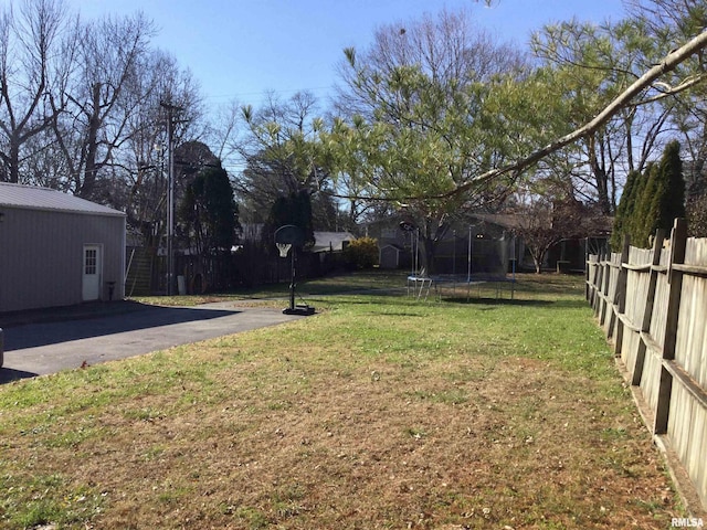 view of yard featuring a trampoline and a patio