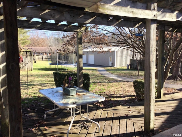 deck featuring a trampoline and a pergola