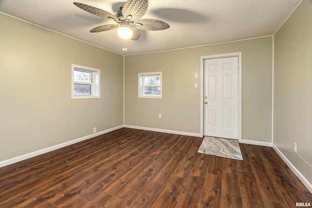 empty room featuring ceiling fan and dark hardwood / wood-style floors