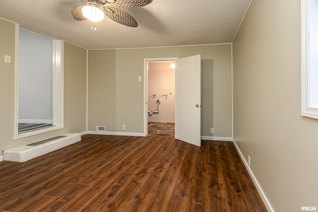 empty room with dark hardwood / wood-style floors and ceiling fan