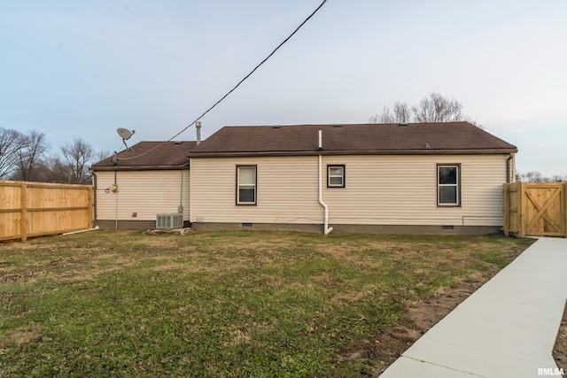 back of property featuring a lawn and central AC unit