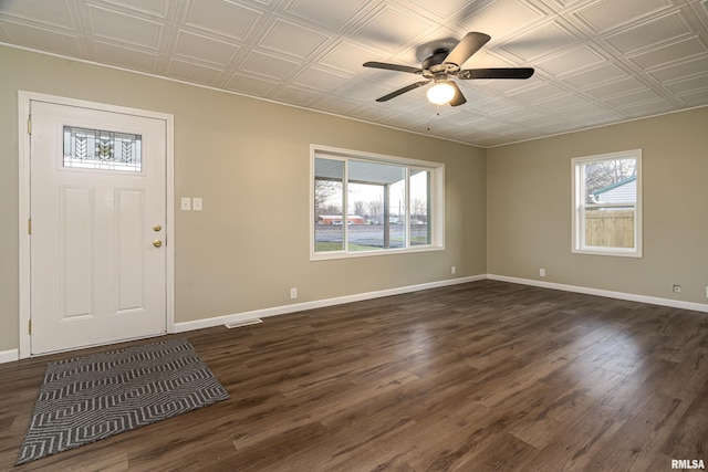 foyer featuring ceiling fan, dark wood-type flooring, and a healthy amount of sunlight