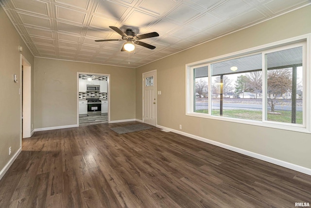 unfurnished living room with ceiling fan and dark wood-type flooring