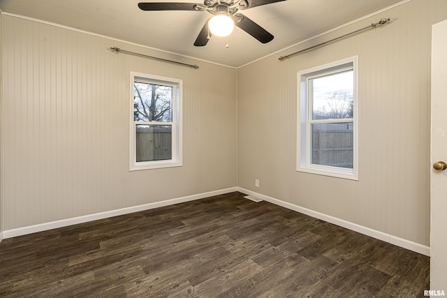 empty room featuring ceiling fan and dark hardwood / wood-style flooring