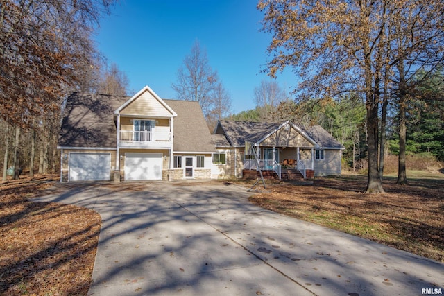 view of front of house with a balcony, covered porch, and a garage