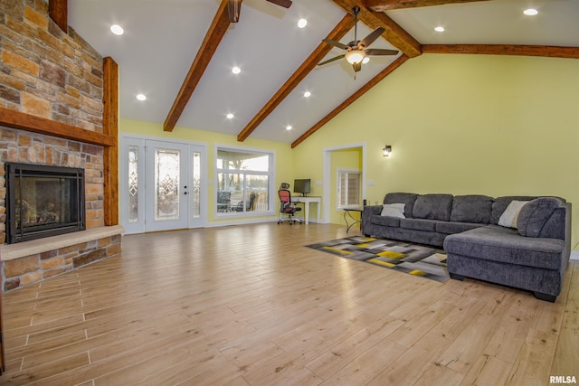 living room with ceiling fan, light hardwood / wood-style flooring, high vaulted ceiling, and beamed ceiling