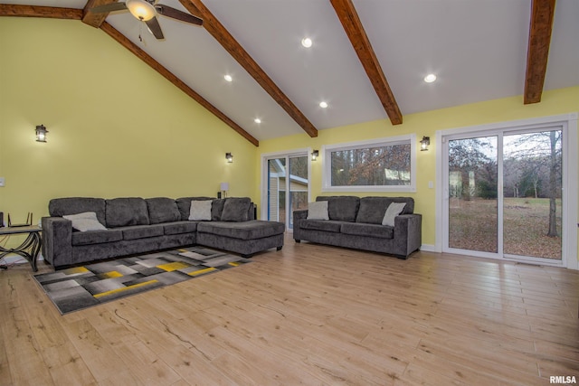 living room featuring beamed ceiling, high vaulted ceiling, and light wood-type flooring