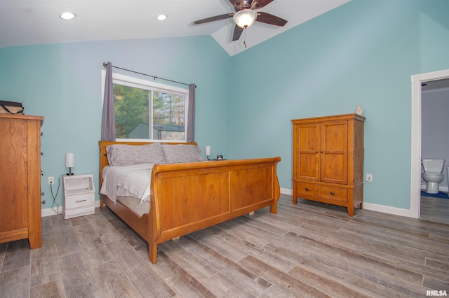 bedroom with hardwood / wood-style flooring, ceiling fan, lofted ceiling, and connected bathroom