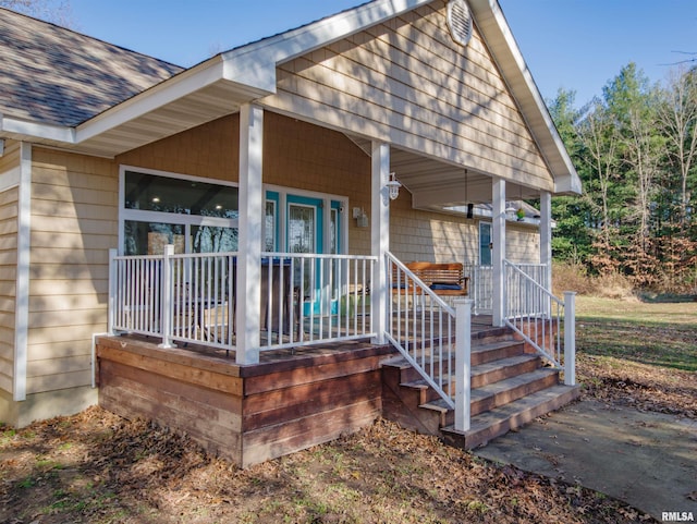 view of exterior entry featuring covered porch