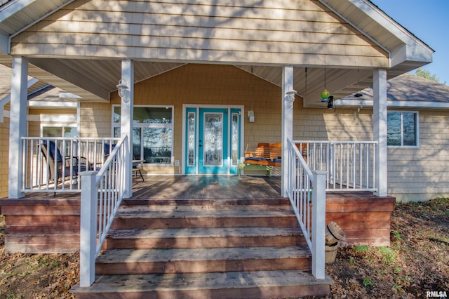 view of exterior entry with covered porch