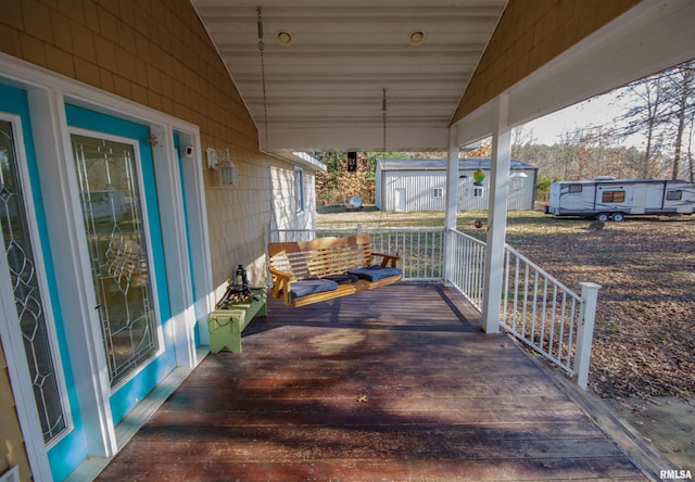 view of patio / terrace featuring covered porch and a storage shed