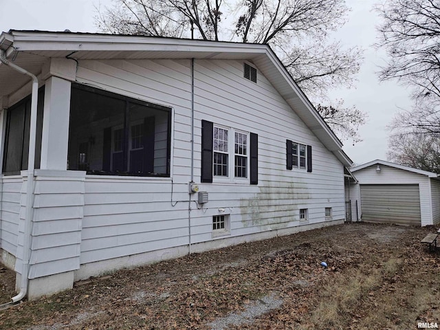 view of side of property with an outbuilding and a garage