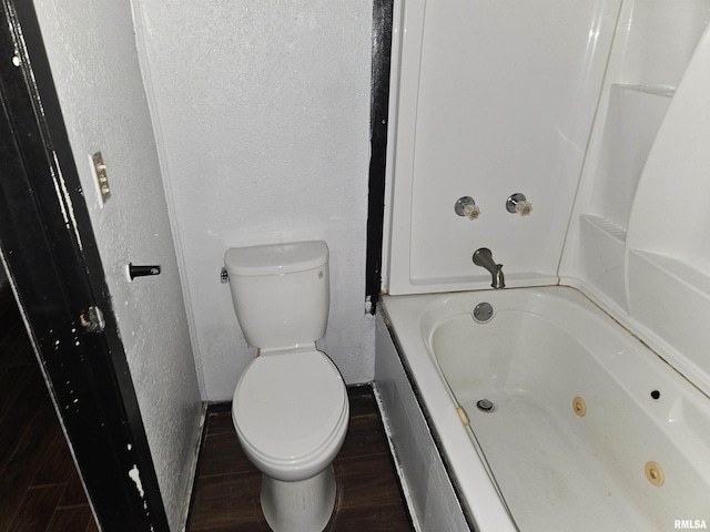 bathroom with wood-type flooring and toilet