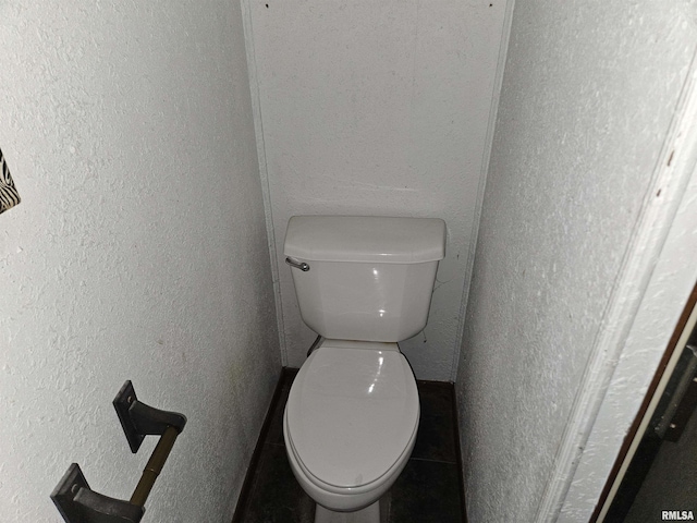 bathroom featuring tile patterned flooring and toilet