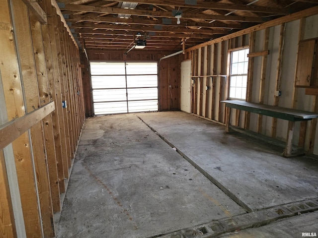 garage featuring electric panel and a garage door opener